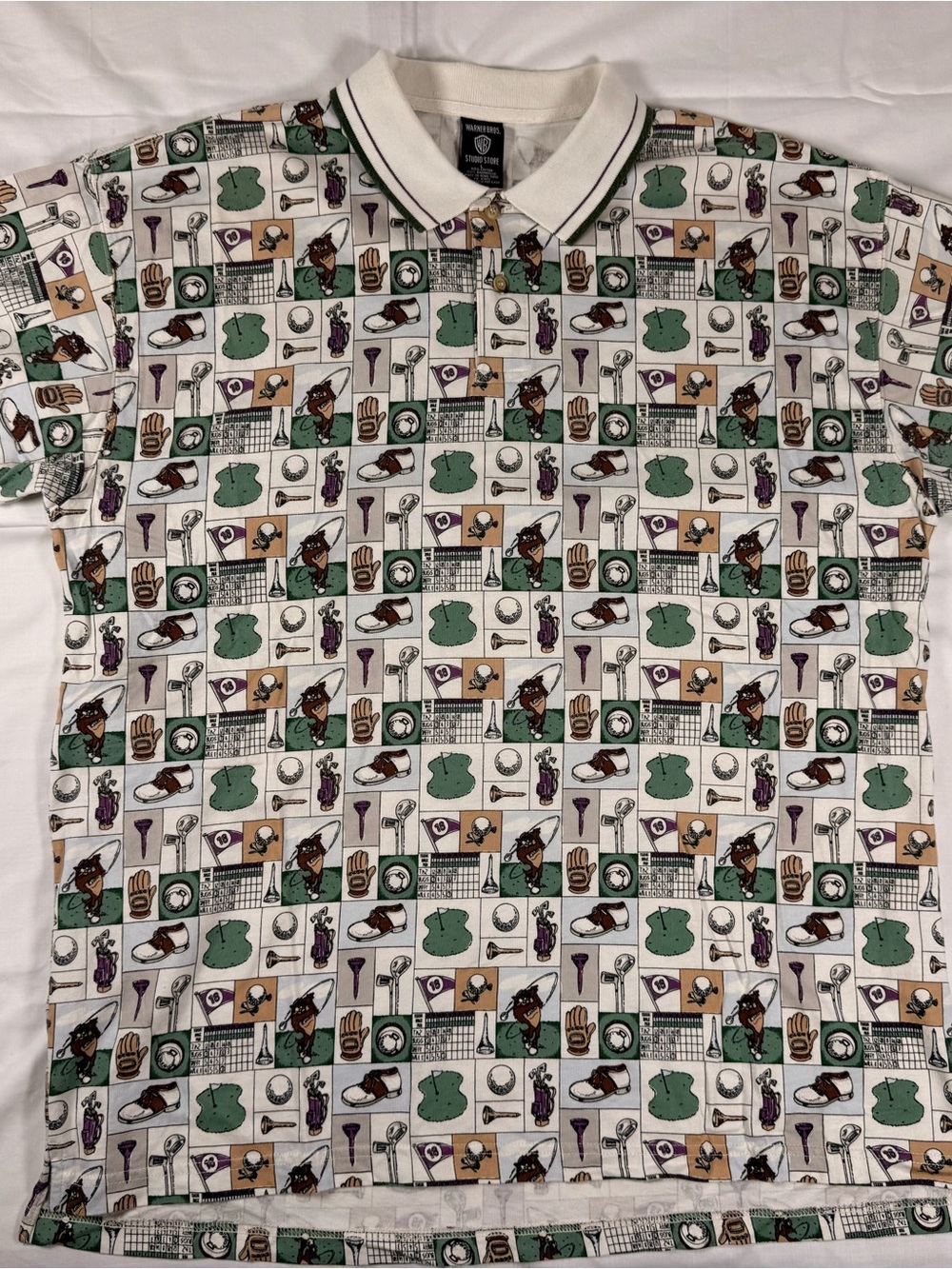 1997 Warner Bros. White Polo Shirt with Green, Tan & Purple Sports Print